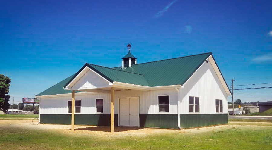 White and green pole building with pitched roof and front porch in Ohio 1