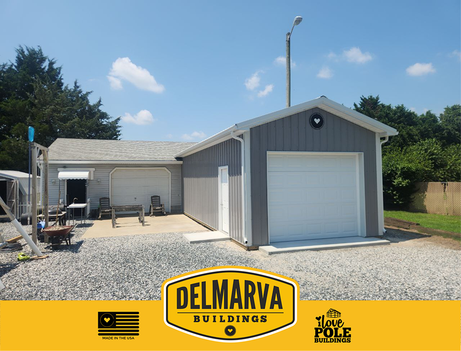 Gray pole barn with black trim, cupolas, and metal roof with multiple windows by Delmarva Buildings.
