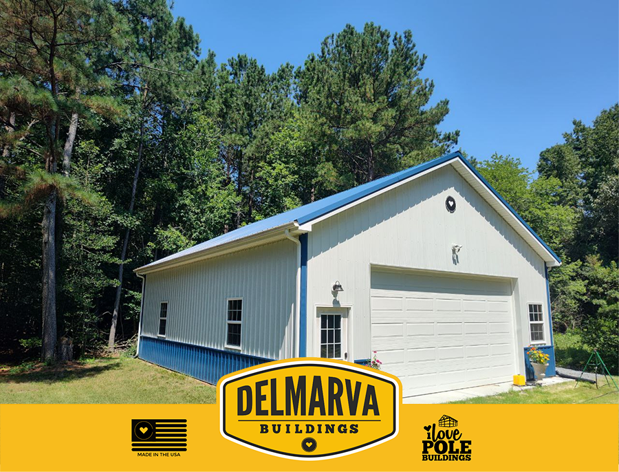White and blue pole barn garage with a white door and multiple windows.