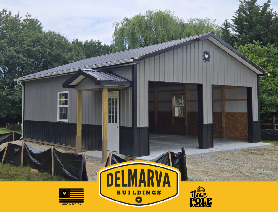 Gray and black pole barn with large open bays and metal roof under construction
