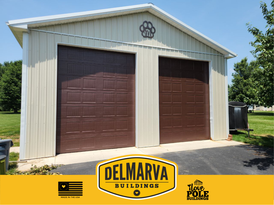 Cream pole barn with brown garage doors and white trim.